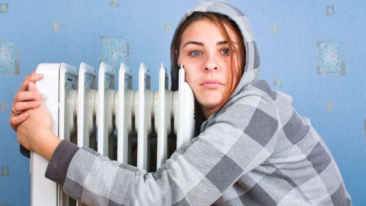The freezing girl about a heater