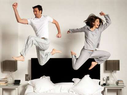 Couple leaping out of bed