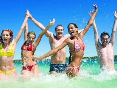 Image of happy teens playing while their vacation