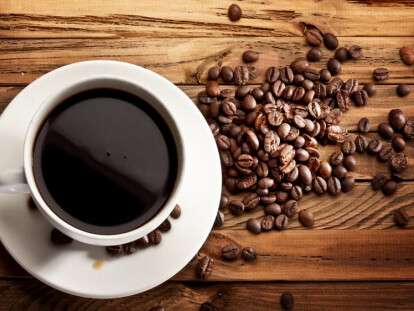 Cup of coffee. View from above on a wooden surface.
