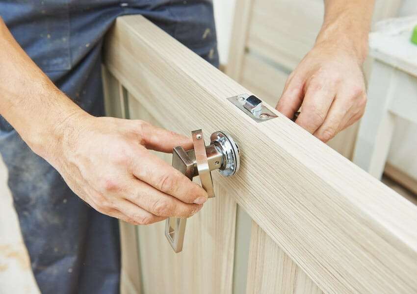 carpenter at door lock installation