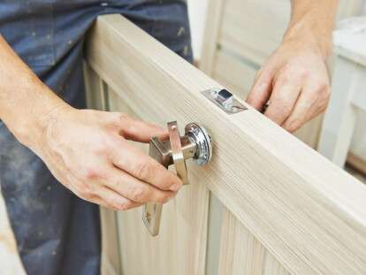 carpenter at door lock installation