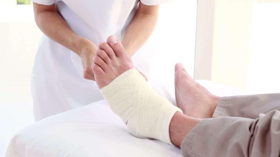 746116194-bandaging-ankle-wrapping-massage-table