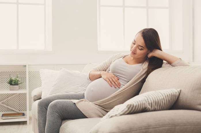 Pensive pregnant woman dreaming about child