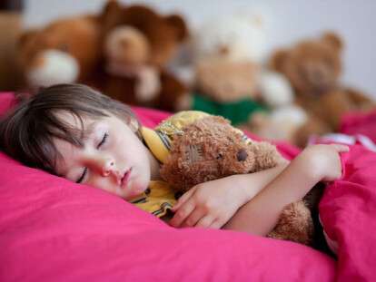 Sweet little boy, sleeping in the afternoon with his teddy bear