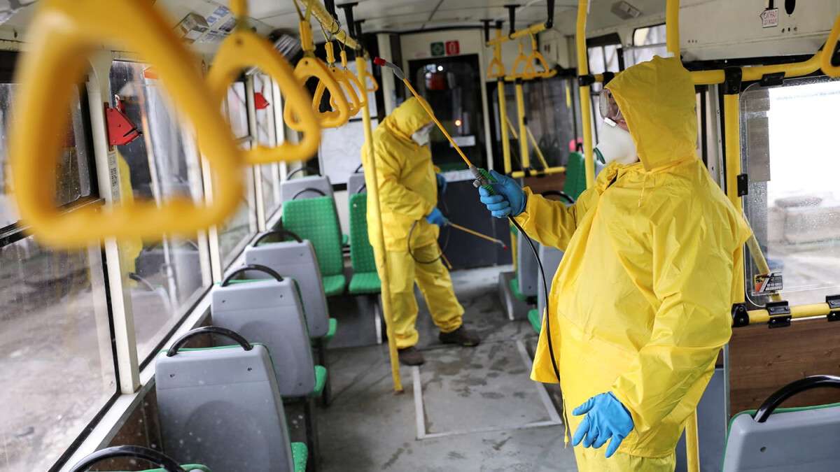 Employees sanitize a bus in Lviv