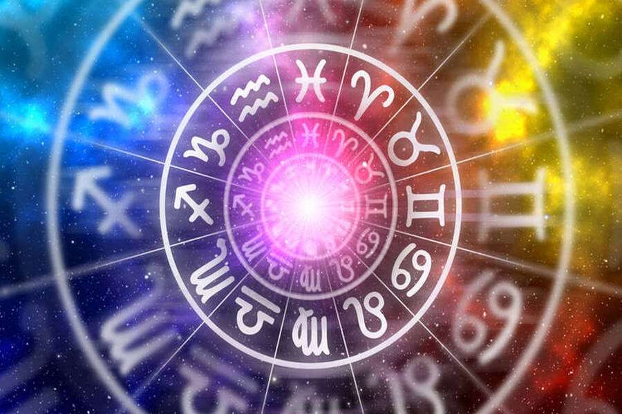 Zodiac signs inside of horoscope circle on universe background