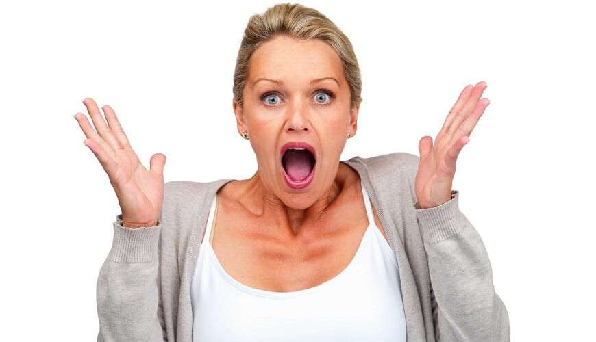 Surprised woman isolated against white background