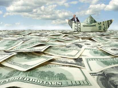 Businessman sailing on dollar boat