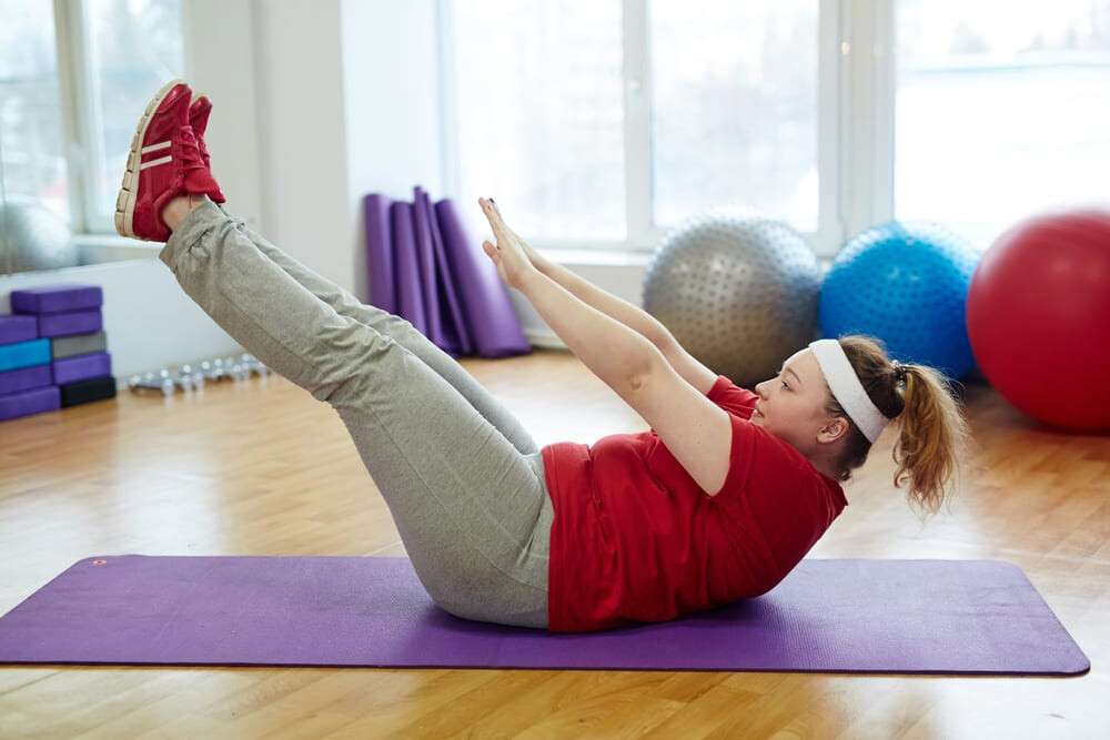 Overweight Woman Working Out Hard in Fitness Studio