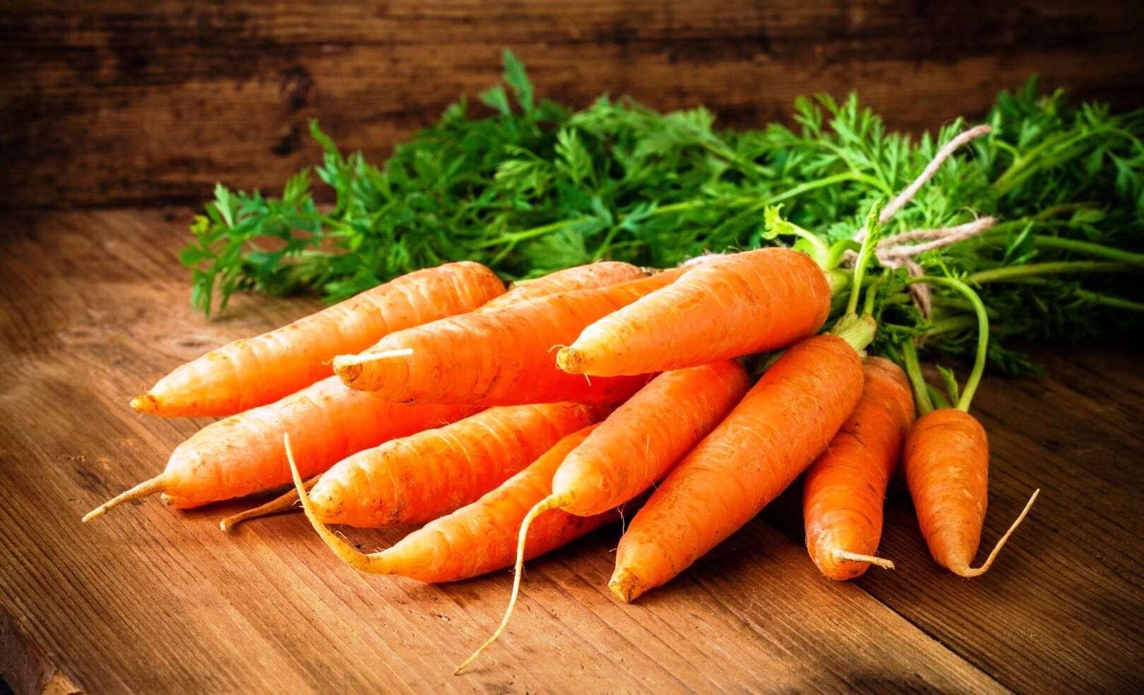 36483107 - fresh carrots bunch on rustic wooden background