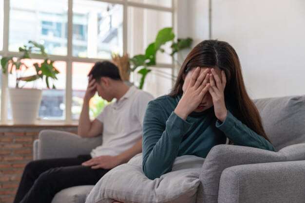 asian-couple-have-problems-beign-in-quarrel-sitting-on-sofa-in-living-room-and-young-woman-is-very-upset-and-crying_34755-477