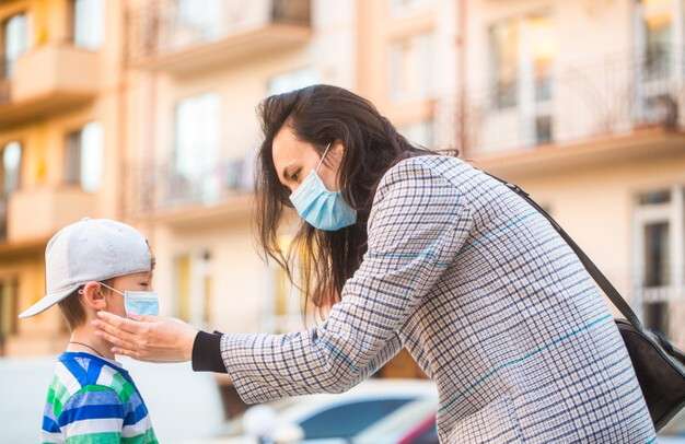 medical-mask-to-prevent-coronavirus-coronavirus-quarantine-mother-puts-a-safety-mask-on-her-son-s-face-schoolboy-is-ready-go-to-school_293990-310