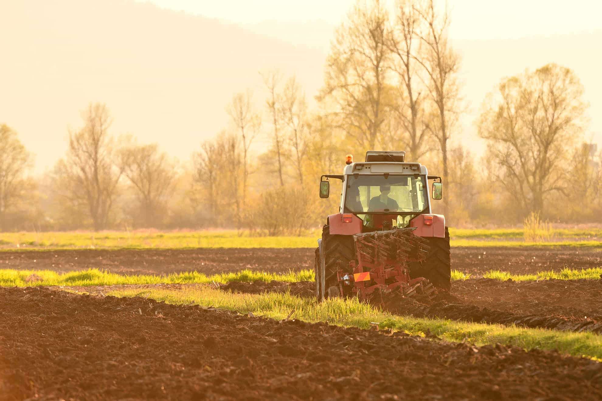 farmer-plowing-soil-at-sunset-in-spring-season-p4jmf6v-min