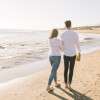 couple-walking-on-the-beach_23-2148111752