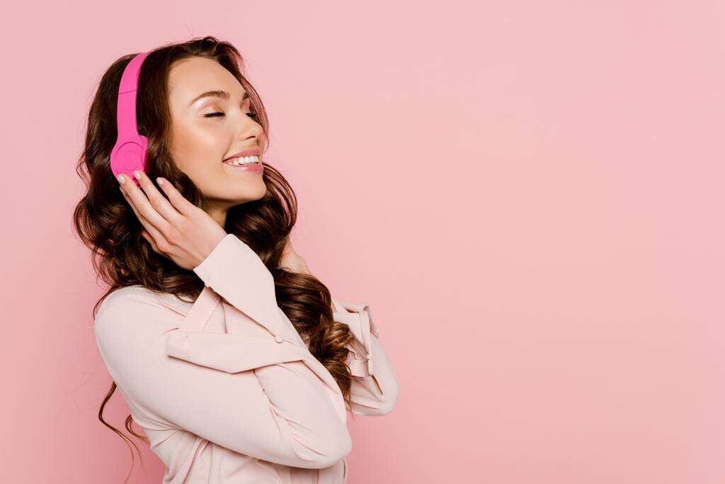 stock-photo-cheerful-girl-listening-music-wireless